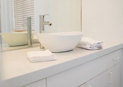 A chic white basin sink that has been installed during a bathroom remodel
