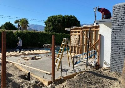 The team at Squared Construction laying down and smoothing a concrete foundation.