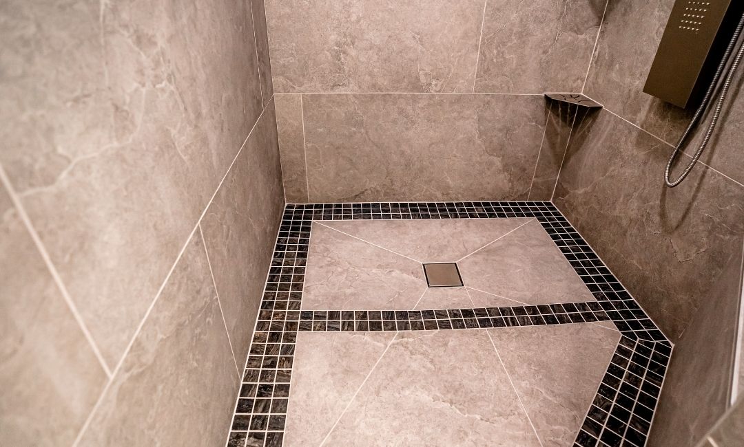 Custom tiles that have been added to the floor of a shower during a bathroom remodeling