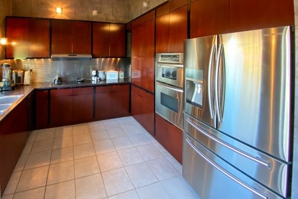 The final result of a completed kitchen remodeling. The kitchen now features custom made cabinets with a dark stain.