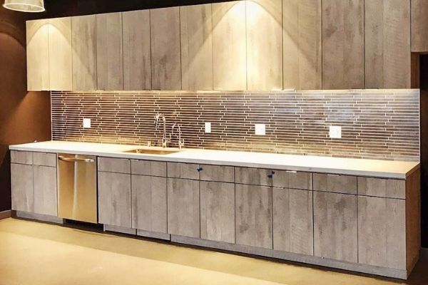 A newly installed kitchenette with a unique metal blacksplash