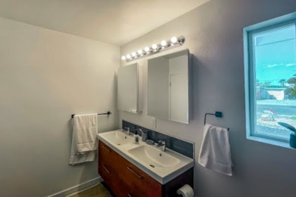 A simple bathroom remodel where new cabinets and lighting have been added.